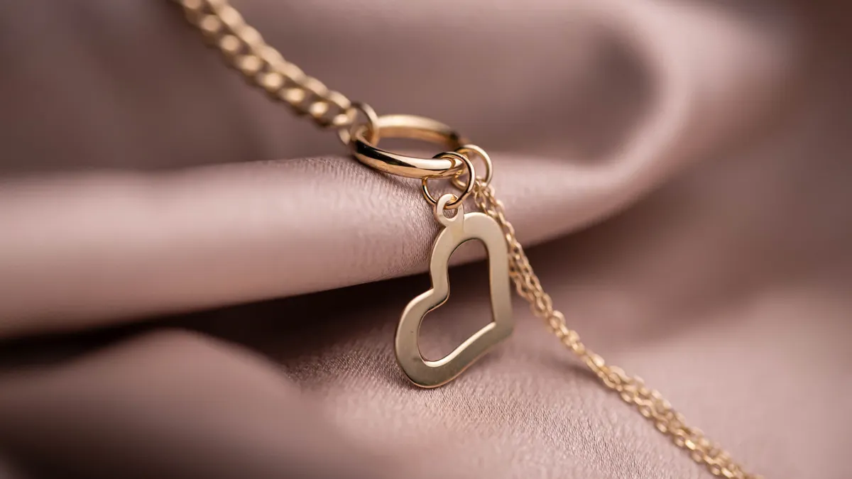 How to choose a chain type for a pendant: cable, box, curb, rope, and snake Gold necklace with a heart pendant on satin