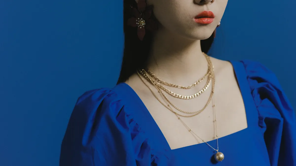 Woman wearing layered pendant necklaces